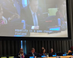 Ministeri Ville Tavion kuva suurella näytöllä ja ministeri puhumassa, kuvassa tekstitys equality is a gamechanger in Finland
